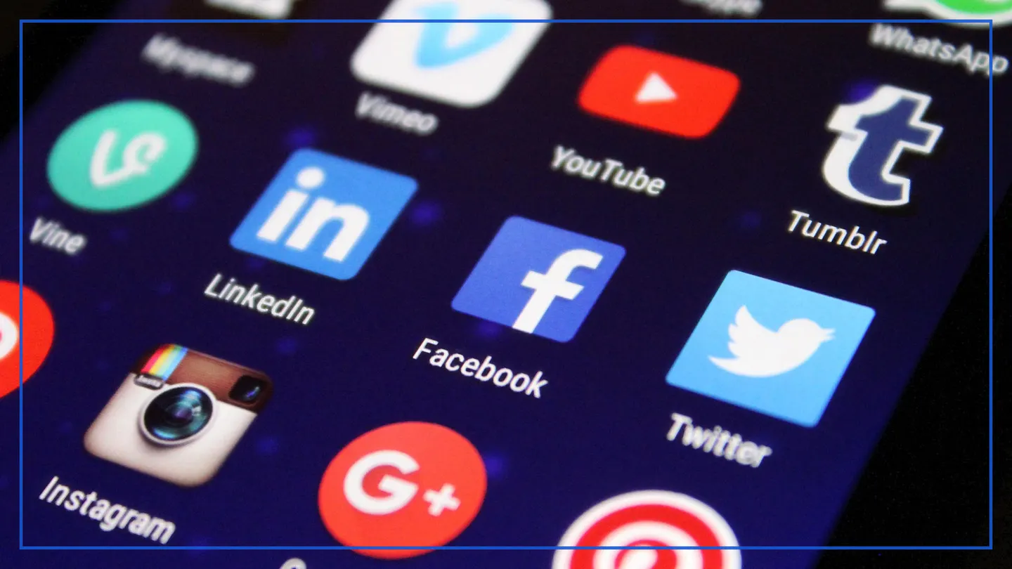 Close-up of a phone screen full of social media app icons such as Facebook, LinkedIn, YouTube and Instagram