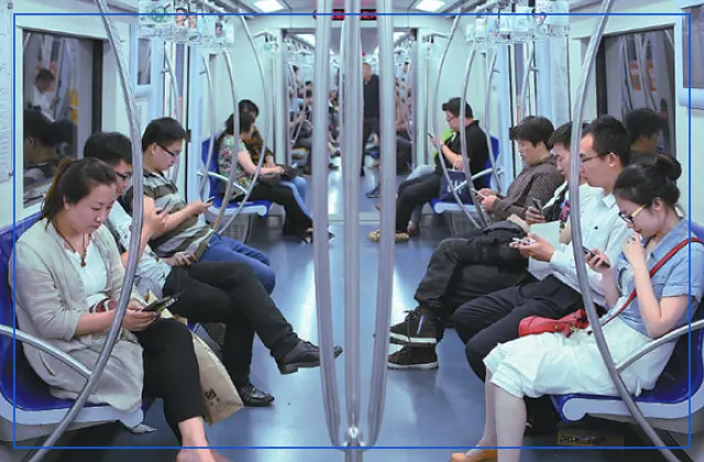 Passengers using their smartphones in a Chinese metro car