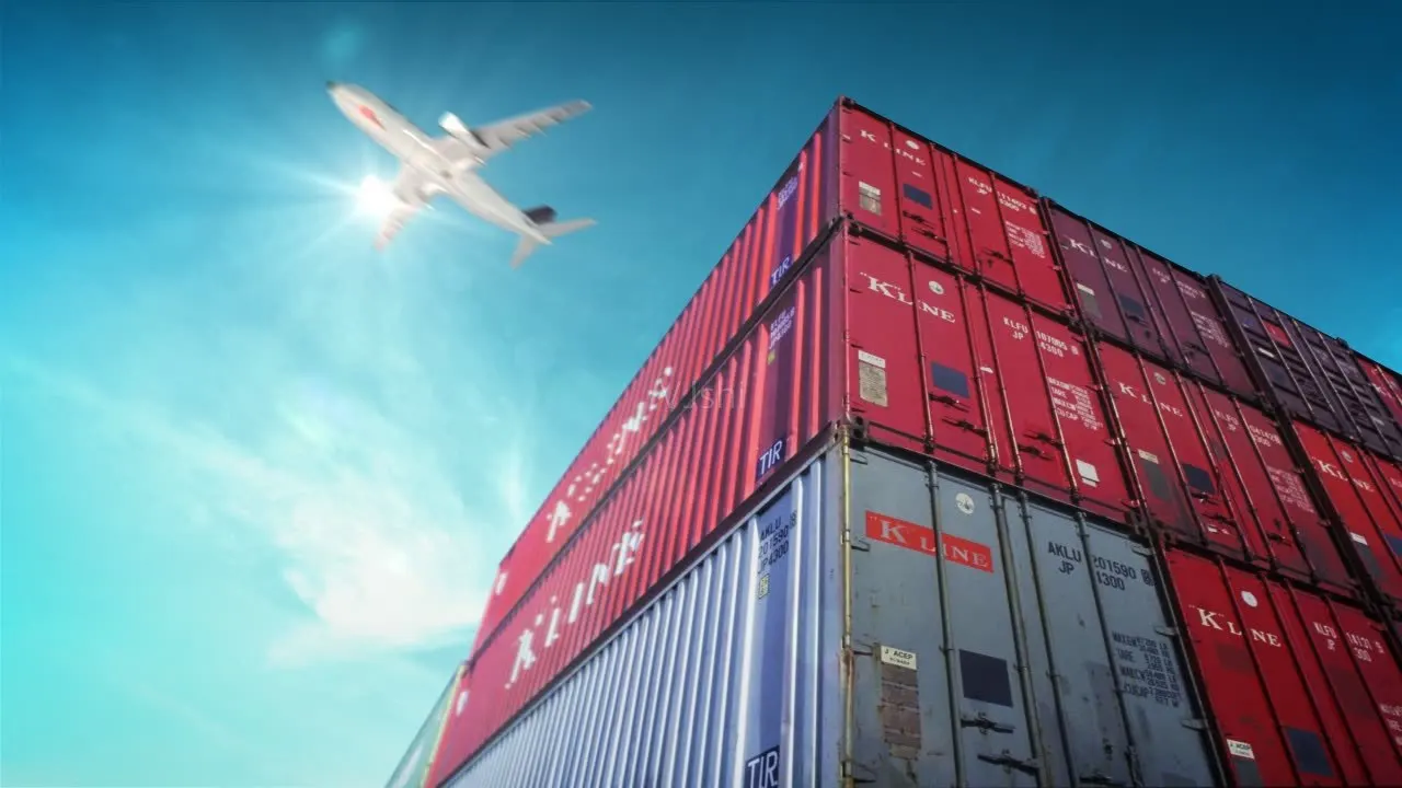 Stacked red and gray shipping containers under a plane in flight, illustrating cross-border logistics
