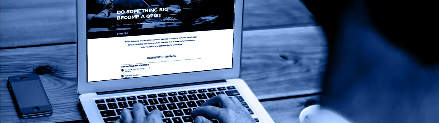 A laptop and a phone showing the QPSoftware careers page
