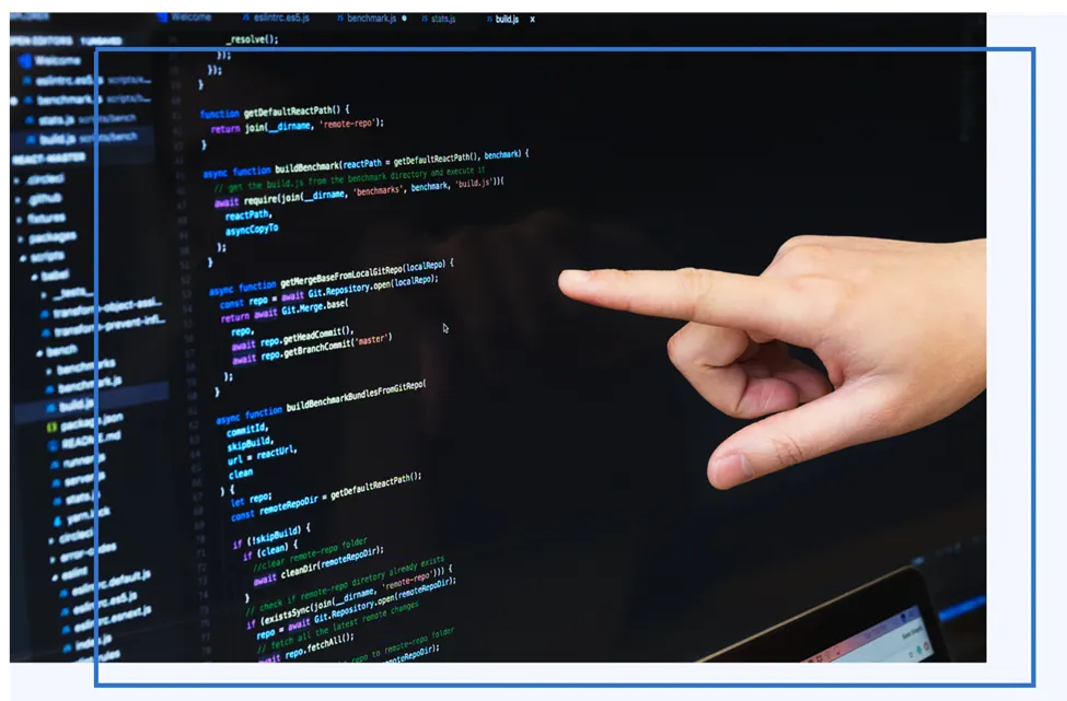 Finger pointing at JavaScript code on a computer screen
