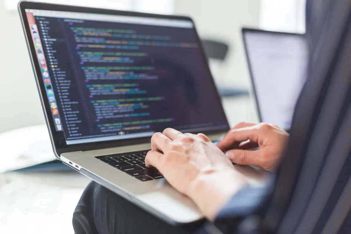 Developer typing code on a laptop
